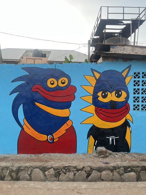Two Sproto Gremlins painted on a blue wall in Nigeria